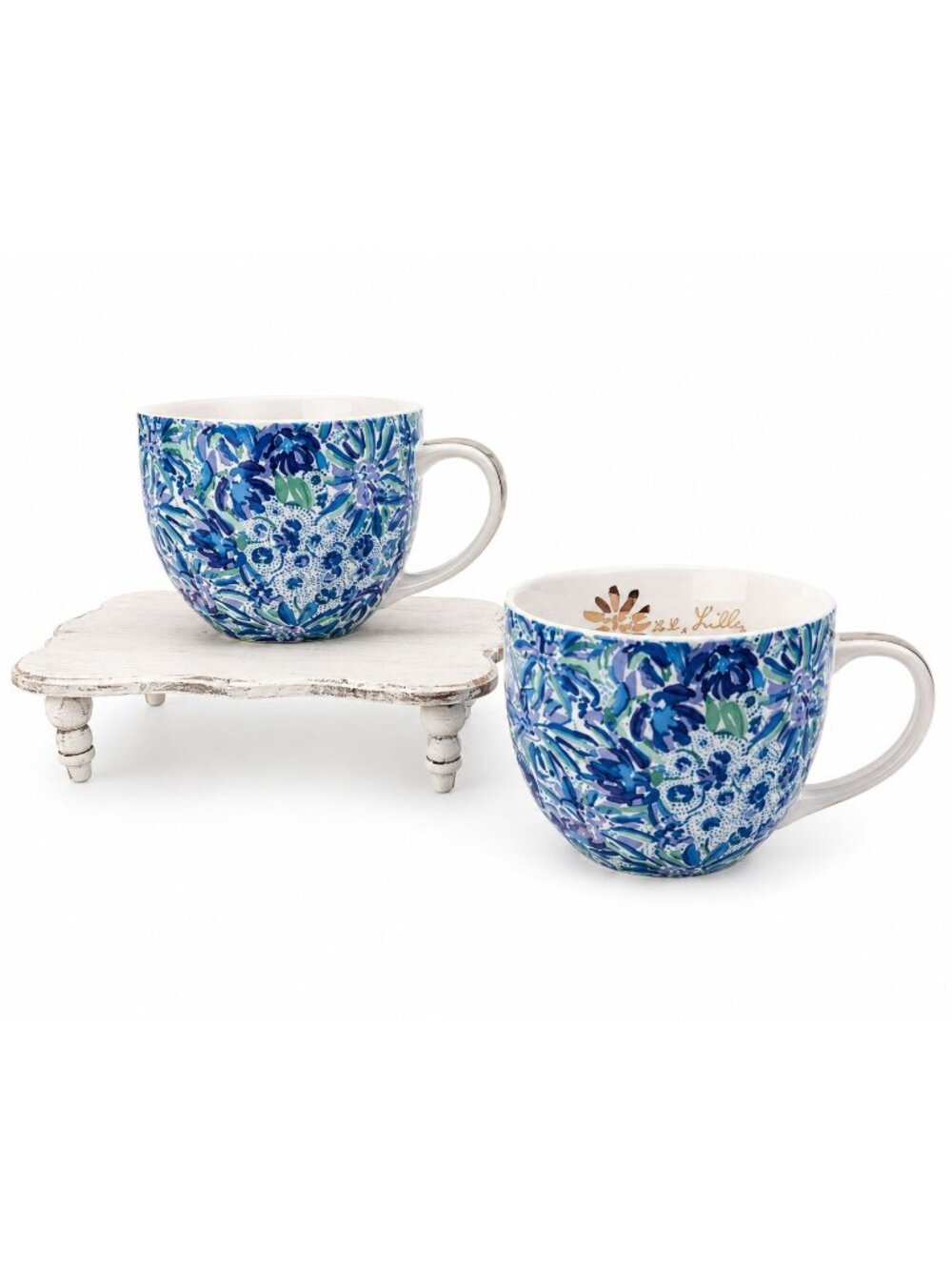 Lilly Pulitzer ceramic mug set features a vibrant blue "Lion Around" floral Patt